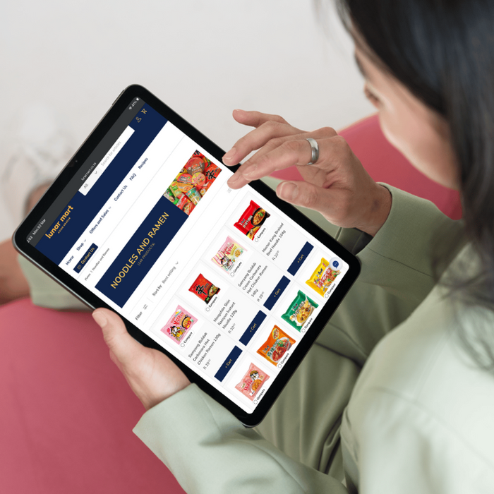 Person using a tablet with a shopping app on a white background